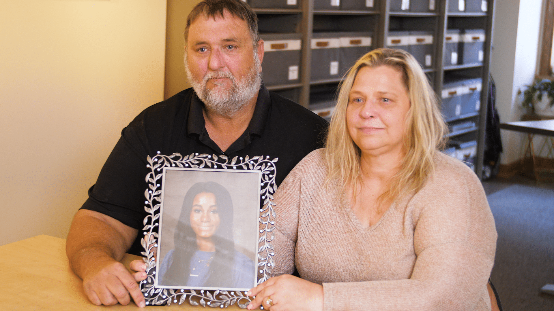 Jenny and Jim Orr hold a picture of their daughter Kelcy